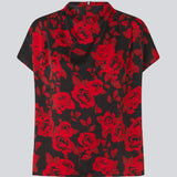 Kortærmet top i et smukt rosenprint. Ruthiemd print SS top har høj hals, skjult lynlår i ryggen og er lavet i genanvendt polyester - en klassisk og elegant style