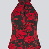Halterneck top i et smukt rosenprint. Ruthiemd print top har en flot bar ryg og er lavet i genanvendt polyester - en klassisk og elegant styles.