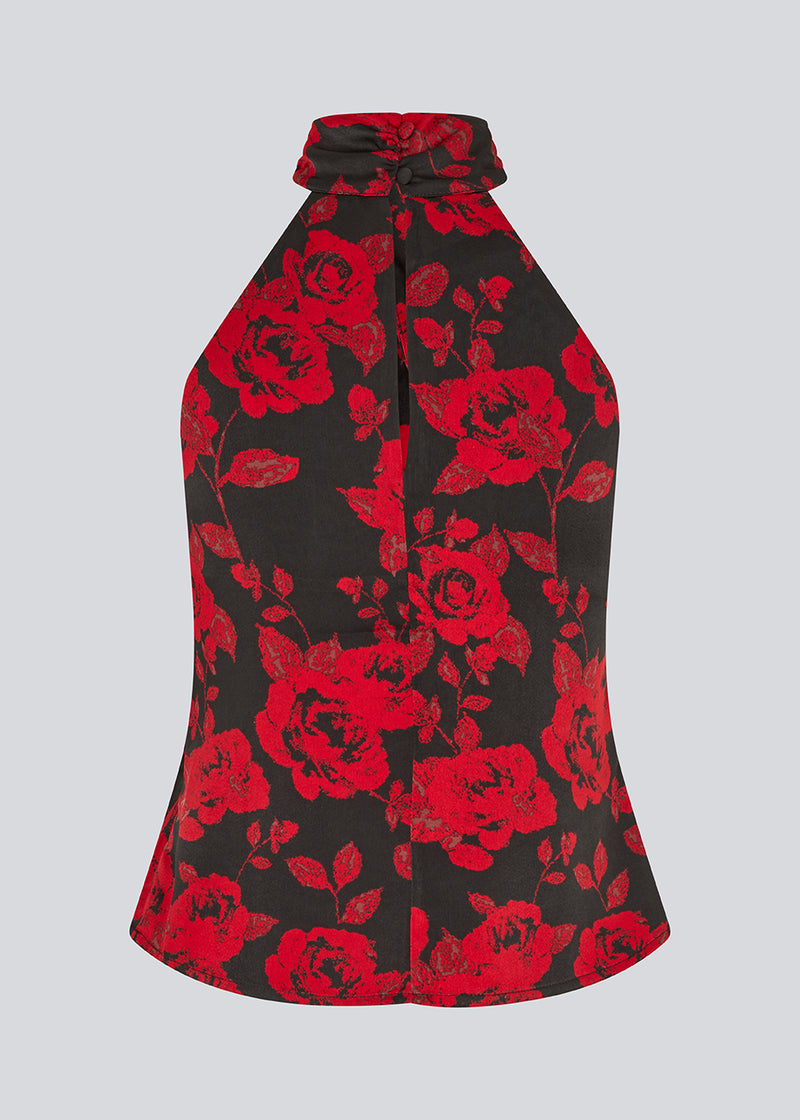 Halterneck top i et smukt rosenprint. Ruthiemd print top har en flot bar ryg og er lavet i genanvendt polyester - en klassisk og elegant styles.