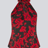 Halterneck top i et smukt rosenprint. Ruthiemd print top har en flot bar ryg og er lavet i genanvendt polyester - en klassisk og elegant styles.