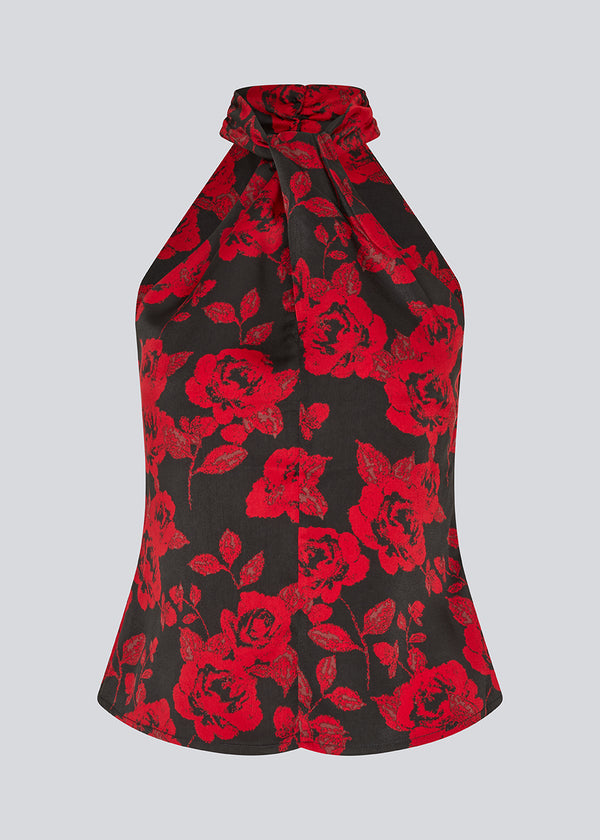 Halterneck top i et smukt rosenprint. Ruthiemd print top har en flot bar ryg og er lavet i genanvendt polyester - en klassisk og elegant styles.