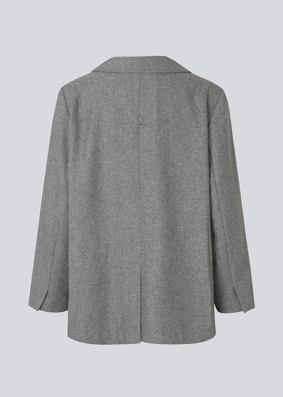 Grå blazer i uldblanding. Simonmd blazer har krave, lange ærmer og to rummelige lommer. Den lukkes med en enkel, synlig knap og er perfekt som overgangsjakke eller som et varmt lag over en t-shirt i vintermånederne.