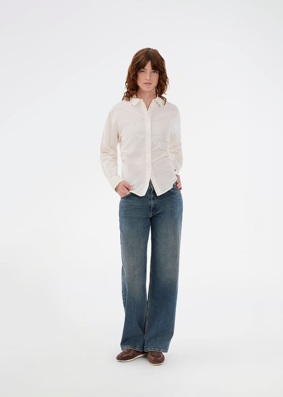 Moderne hvid skjorte med fiminint udtryk. Siobanmd shirt har klassiske detaljer som krave, knappelukning og lange ærmer. Rynkesyninger i taljen skaber en smuk, feminin silhuet. Fremstillet i 58 % økologisk bomuld.