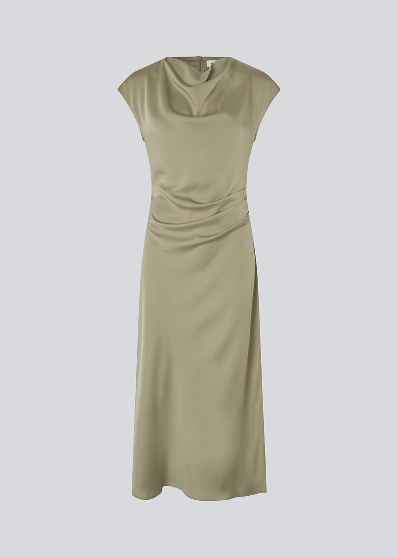 Lang ærmeløs kjole i grøn med rynkedetalje i satin. TailorMD dress har en høj hals, usynlig lynlås i ryggen og en slids i siden.&nbsp;