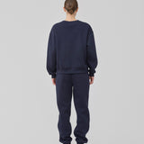 Sweatpants i mørkeblå i bomuldsblanding med logo. TiaMD pants har sidelommer, bindebånd og elastik i benene og taljen.