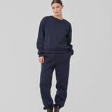 Sweatpants i mørkeblå i bomuldsblanding med logo. TiaMD pants har sidelommer, bindebånd og elastik i benene og taljen.