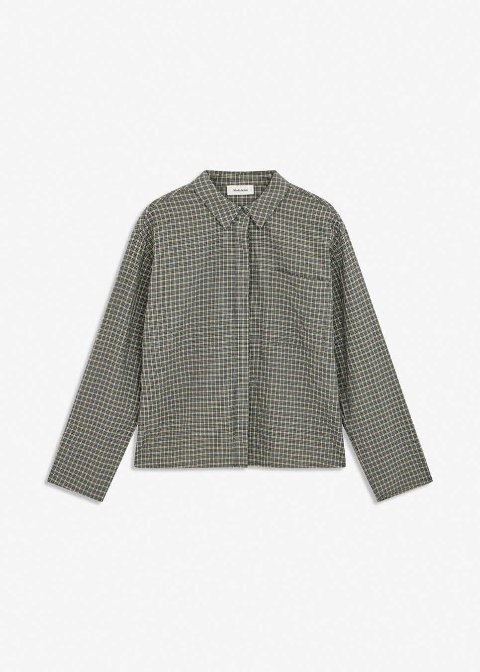 TikkaMD Shirt er en kort skjorte med løs pasform og klassisk ternet mønster. Designet har skjortekrave, skjult knaplukning og en brystlomme. Style den med jeans eller matchende tern for et komplet look.