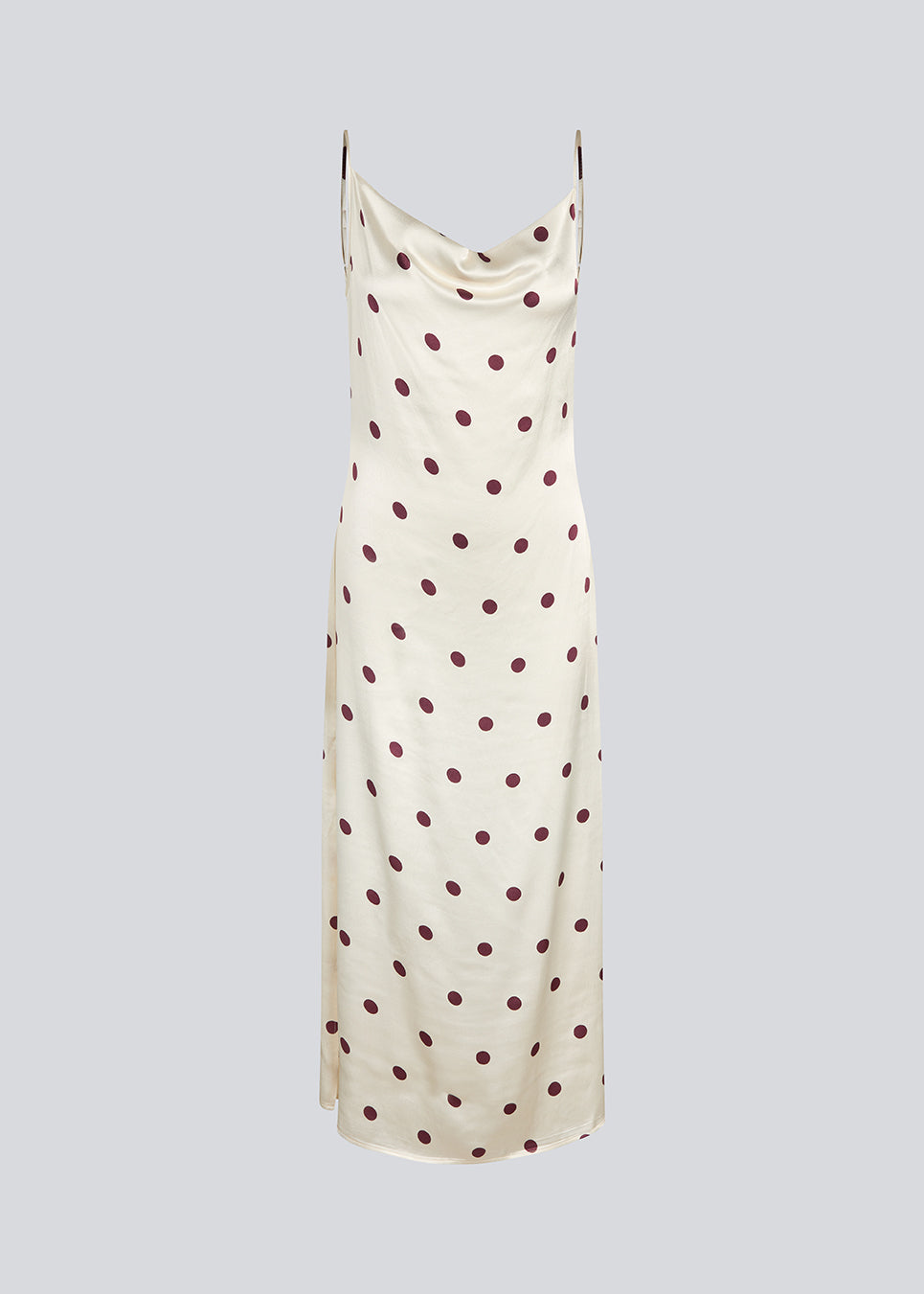 Lang kjole i satin med polkaprikker. Vanjamd Print Dress har fine spaghettistropper, vandfaldsudskæring og et løst, elegant fald, der skaber et feminint og moderne udtryk. 