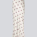 Lang nederdel i hvid satin med polkaprikker. Vanjamd Print Skirt har et løst, elegant fald og elastik i taljen for et behageligt og feminint udtryk. Perfekt til både hverdags- og aftenlooks.&nbsp;