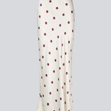 Lang nederdel i hvid satin med polkaprikker. Vanjamd Print Skirt har et løst, elegant fald og elastik i taljen for et behageligt og feminint udtryk. Perfekt til både hverdags- og aftenlooks.