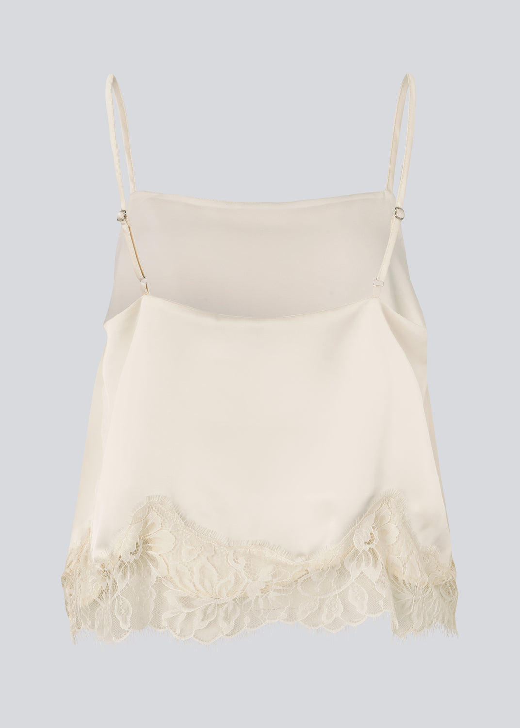 Delikat hvid top i satin. Vuemd top har justerbare stropper og fine blondedetaljer i bunden. Ideel alene eller stylet som en del af en lag-på-lag styling.