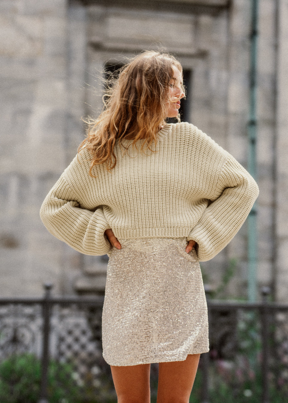 Grovstrikket trøje i beige i bomuldsstrik med bred, rund hals og let cropped længde. FlakaMD o-neck har en afslappet silhuet med ekstra lange ballonærmer. Modellen er 175 cm og har en størrelse S/36 på.