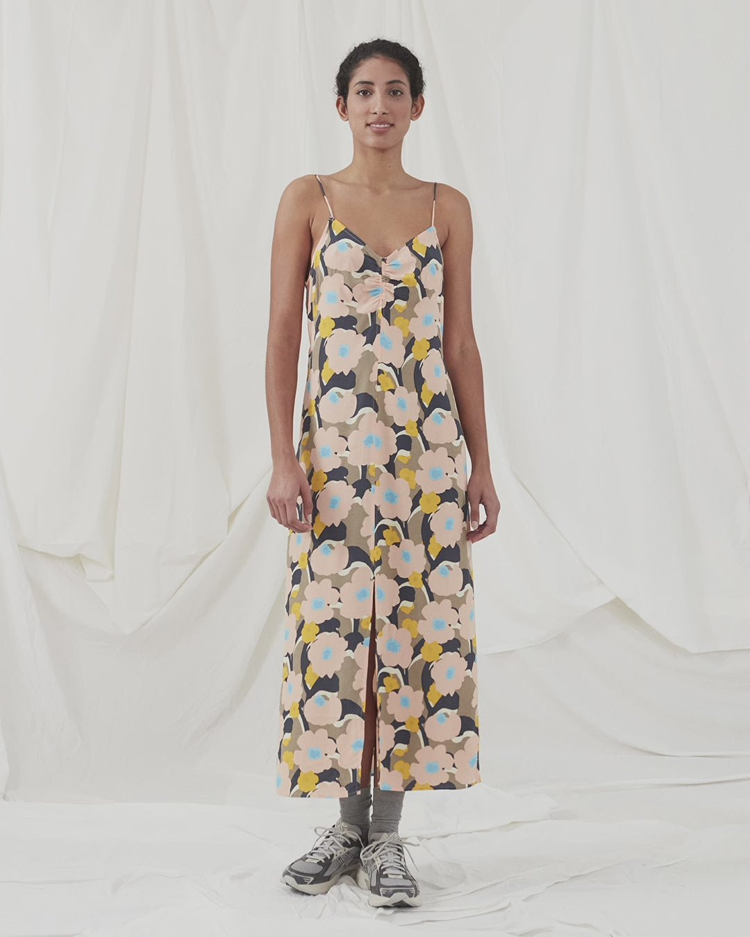 Midi kjole med relaxed fit og blomsterprint. DustinMD print strap dress har v-hals med rynkedetalje i midten, tynde stropper og lynlås bagpå. Slids foran. Modellen er 177 cm og har en størrelse S/36 på.