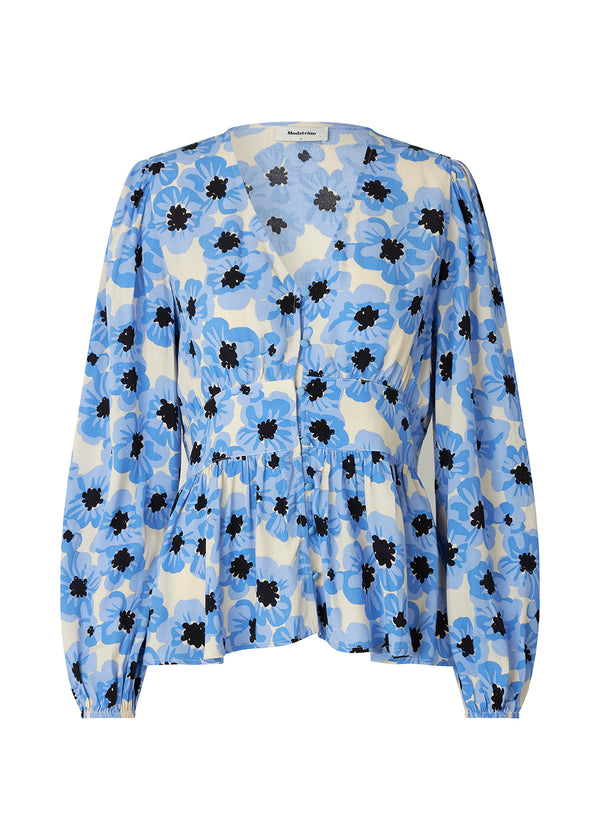 Bluse med lange ballonærmer. TorahMD print top har en dyb v-hals med knaplukning fortil. Blusen har en peplumform med et tætsiddende stykke i taljen.