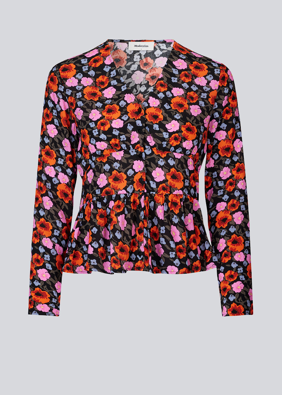 BonMD print top har v-udskæring med knaplukning fortil og skæring i taljen med peplum. Lange, smalle ærmer.