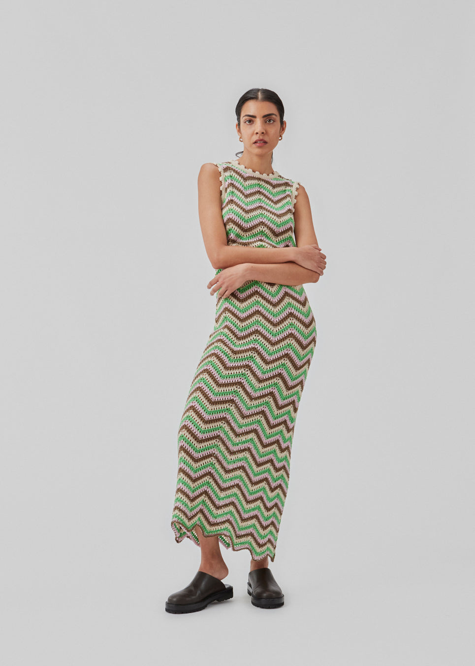 Hæklet lang kjole uden ærmer i multifarvet økologisk bomuld. CaryMD dress har detaljerede kanter og en dyb v-udskæring på ryggen. Modellen er 177 cm og har en størrelse S/36 på.