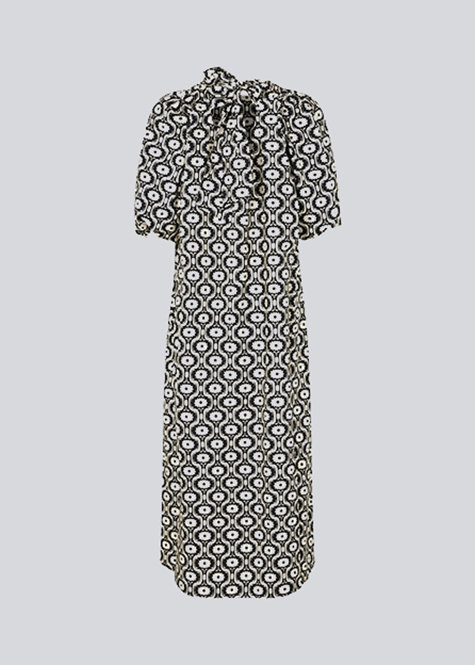 Lang kjole med vidde i skørtet og store pufærmer. CoraMD print dress har en rund hals med udskæring og sløjfe i ryggen. Fremstillet i økologisk bomuld. Modellen er 174 cm og har en størrelse S/36 på.