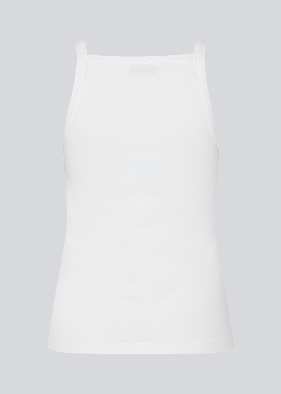 Tætsiddende basic hvid top med høj og lige udskæring i halsen. DaeMD top er fremstillet i en ribstrikket økologisk bomuld. Modellen er 177 cm og har en størrelse S/36 på.